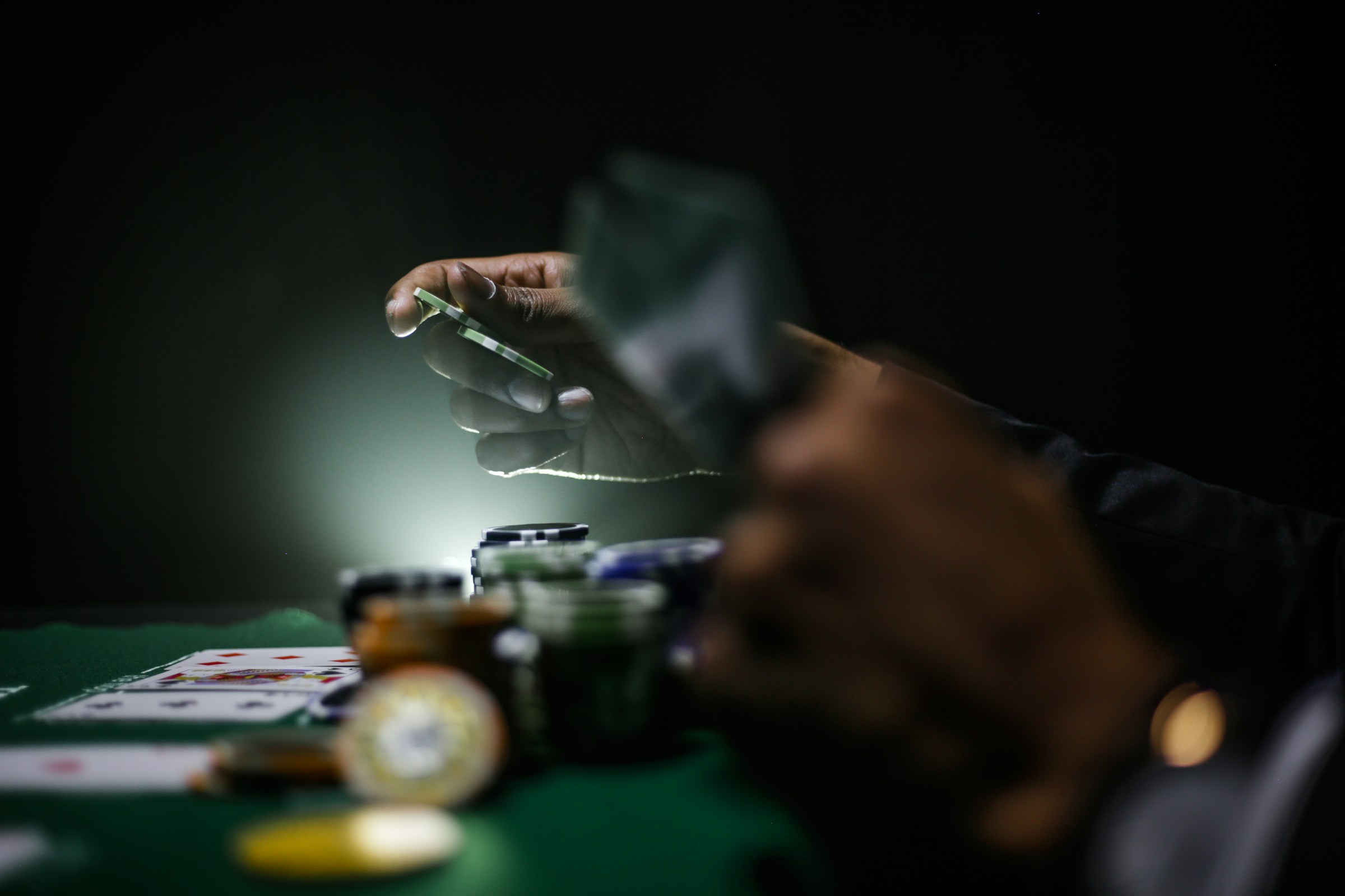 A player places a bet at a poker table